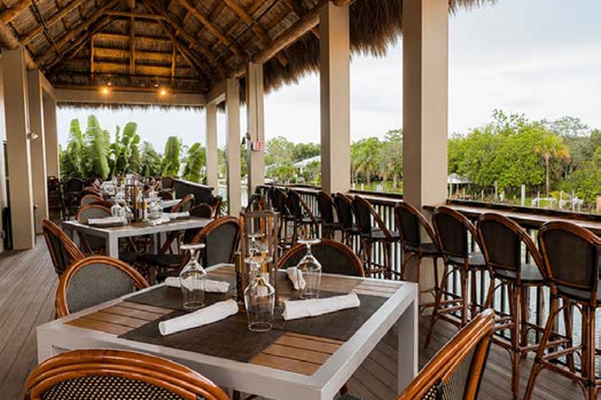 Upstairs Tiki elevated dining area with thatched roof and open-air views